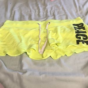Woman’s yellow peace shorts brand No Boundaries!